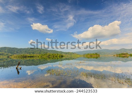 Tropical lake under blue cloudy sky in Thailand.