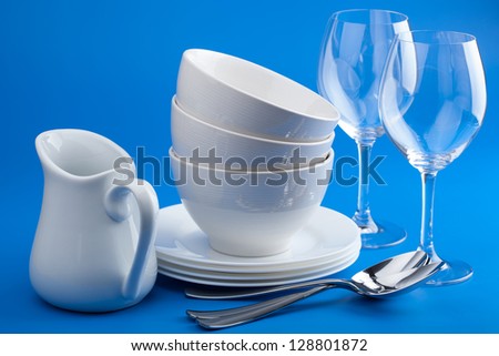 white tableware over blue background