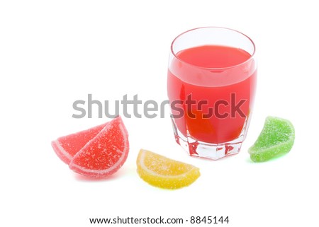 glass of red juice and fruit jellies