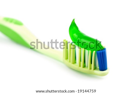 toothbrush with green toothpaste isolated