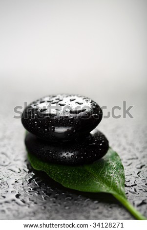 spa stones and leaf with water drops