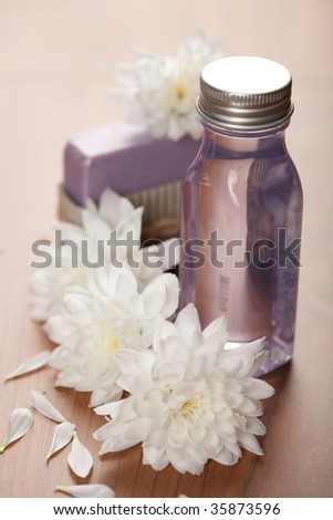 spa and body care - cosmetic bottle and flowers