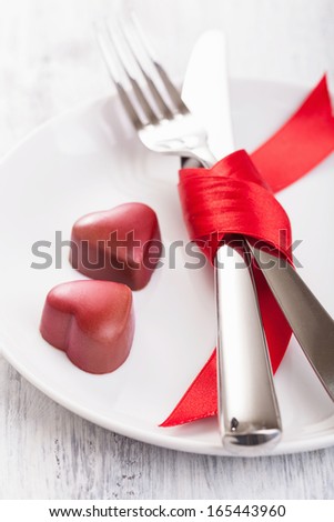 chocolate hearts and silverware on plate for Valentines