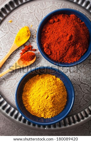 spices in bowls: curry and paprika powder