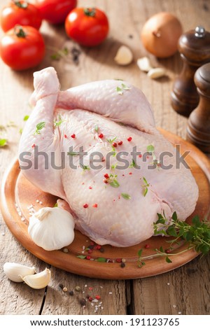 whole raw chicken with rose pepper and thyme