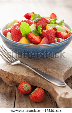 fresh fruit salad with strawberry, apple, nectarine, pomegranate