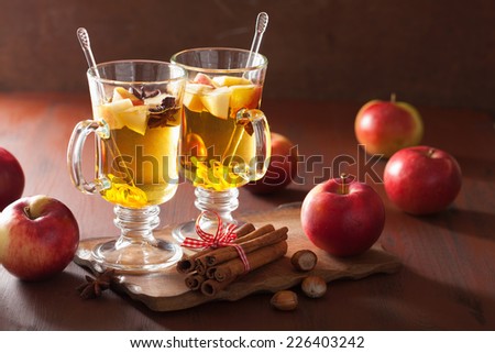 glass of mulled apple cider with  orange and spices, winter drink