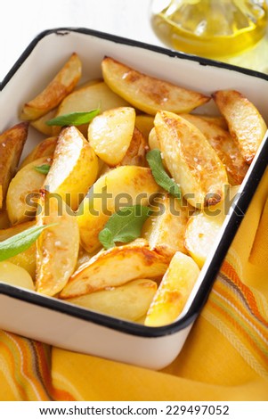 baked potato wedges in enamel baking dish