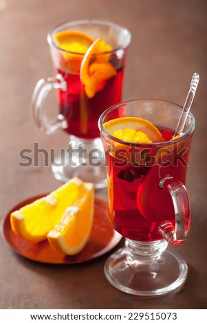 glass of mulled wine with orange and spices, winter drink
