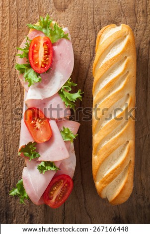 long baguette sandwich with ham tomato lettuce