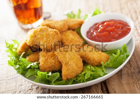 fast food chicken nuggets with ketchup, french fries, cola