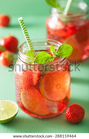 summer strawberry drink with lime and mint in jars