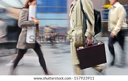 Business people at rush hour walking in the street, in the style of motion blur