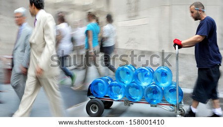 delivery water with dolly by hand, purposely motion blur