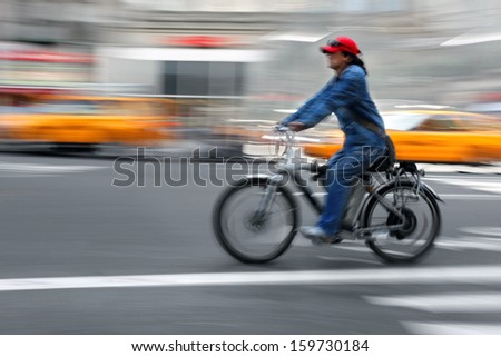 cyclist in traffic on the city roadway motion blur