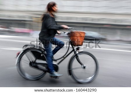cyclist in traffic on the city roadway motion blur