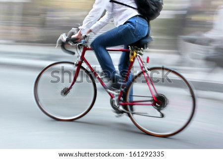 Cyclist In Traffic On The City Roadway Motion Blur