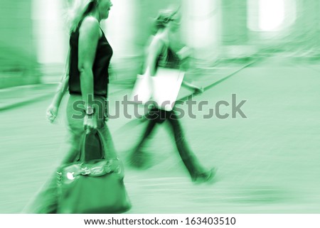 shopping in the city in motion blur and  emerald tonality