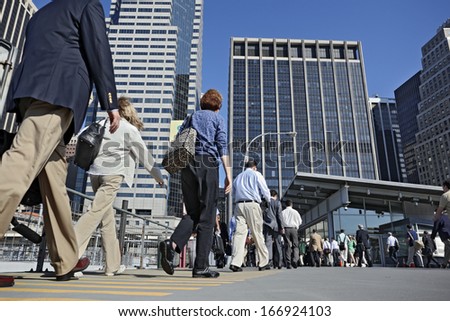 business people at rush hour walking in the street
