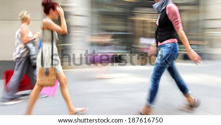 people shopping in the city in motion blur