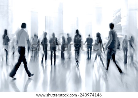 abstract image of people in the lobby of a modern business center with a blurred background and blue tonality