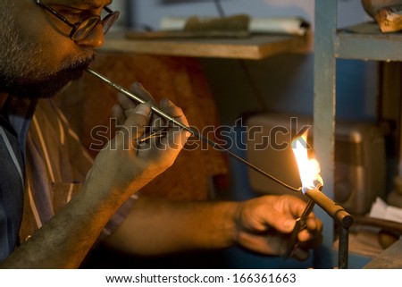 VARANASI, INDIA - MAY 15: Unidentified man working jeweler. Handwork. May 15, 2013 in Varanasi, India. According to legend, Varanasi was founded by Lord Shiva.