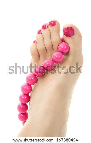female foot with pink pedicure and accessory close up