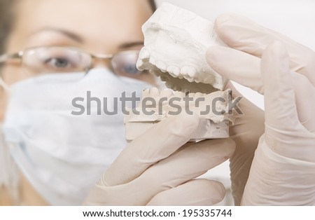 Woman holding a teeth sample