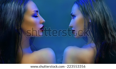 Fashion Beauty. Mystic Make-up. Two mysterious Beautiful Womans With Luxury glossy Makeup. Beautiful sensitive Girl Face. Constellation of the Twins (blue filter)
