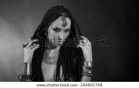 Fashion Beauty. Mystic Make-up. Beautiful Woman With Luxury glossy Makeup and stylish hair (dreadlocks) . Beautiful sensitive Girl Face, indian accessories (oriental jewelry). black and white