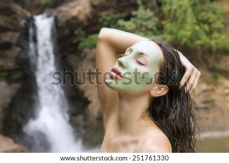 Spa Outdoor, Beautiful young woman lying with natural green facial mask on her face