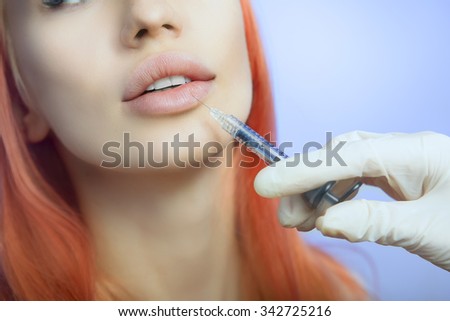 Young Woman Geting an Injection in her Lips in Beauty salon. Beauty Injections -Woman in the beautician office. Increase the Lips by Hyaluronic acid, Contouring procedure, revitalization