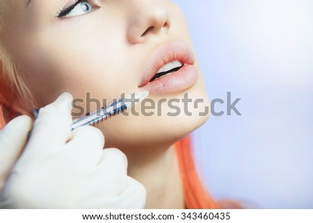 Young Woman Geting an Injection in her Lips in Beauty salon. Beauty Injections -Woman lying in the beautician office. Increase the Lips by Hyaluronic acid, Contouring procedure, revitalization