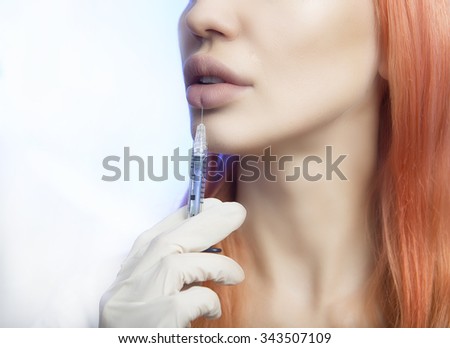 Young Woman Geting Injection in her Lips. Beauty Injections - Woman wondered about methods lip augmentation in beautician office. Increase Lips by Hyaluronic acid, Contouring procedure, revitalization
