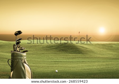 golf equipment on green and hole as background. vintage tone