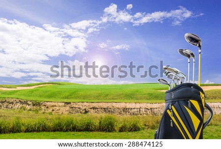 golf equipment and golf bag on green and hole as background.