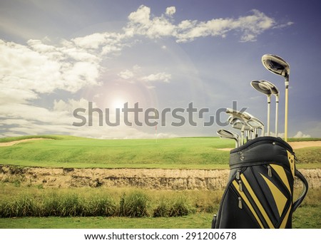 golf equipment and golf bag on green and hole as background.vintage tone