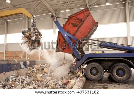 Truck dumps waste to the incinerator, grab take the rubbish