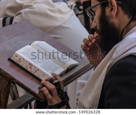 JERUSALEM - JULY 31 - Orthodox Jews prays at the Western Wall - July 31, 2013 in the old city of Jerusalem, Israel. The western wall is the holiest place in Jewish tradition
