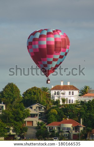 HAMILTON, NZ - MARCH 28, 2010: Hot Air Balloons flying above Lake Rotoroa (Hamilton Lake Domain), in Hamilton, New Zealand. This is part of the Balloons over Waikato event