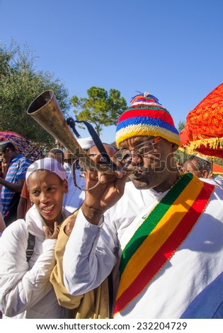 JERUSALEM - NOV 20, 2014: A Kes, religious leader of the Ethiopian Jews, plays a shofar to mark the end of the Sigd prays, in Jerusalem, Israel. The Sigd is an annual holiday of the Ethiopian Jews