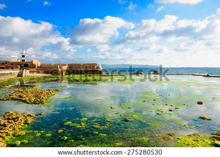 ACRE, ISRAEL - MAY 04, 2015: Scene of a Templar Fortress remains, lighthouse, restaurants, local fishermen and Haifa bay, in the old city of Acre, Israel
