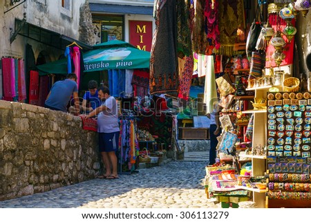 MOSTAR, BIH - JULY 06, 2015: Scene of the old city, with local businesses, backgammon players, locals and tourists, in Mostar, Bosnia and Herzegovina