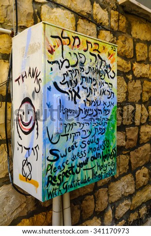 SAFED, ISRAEL - NOVEMBER 17, 2015: A communication box with a graffiti about modesty dress of women, in Safed (Tzfat), Israel