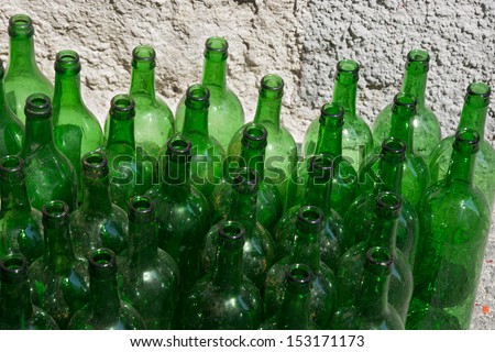 Green dirty empty wine bottles close-up