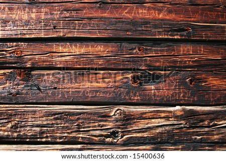 Old wooden wall background. Detail of wall board with engrave letter and words.
