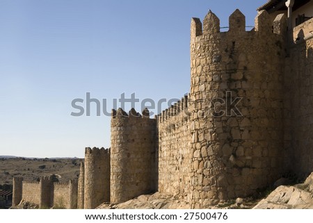 Avila medieval city walls. Wall constructed of brown granite in 1090 with towers.  Avila old city is a UNESCO World Heritage Site - Spain