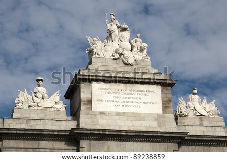 Madrid - Puerta de Toledo detail. A group of sculptures sitting on top of the central arch represent the power in medieval times of the Spanish monarchy - Spain