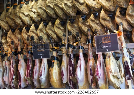 MADRID - OCTOBER 02: Serrano ham ( jamon iberico) stall at San Miguel Market on October 02, 2014 in Madrid. Also called Pata Negra, the renowned cured spanish ham is served raw in thin slices