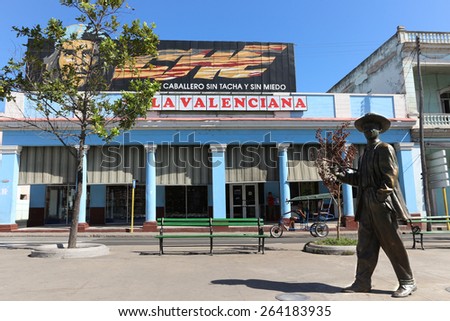 CIENFUEGOS, CUBA - FEBRUARY 7: Bronze statue of Benny More and Guevara billboard, Paseo del Prado on February 7, 2015 in Cienfuegos. . MorÃ© was a master of most genres of cuban music.